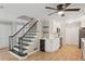 Bright kitchen boasts wooden floors, stainless appliances, white cabinets, and a staircase at 3308 Quail Run Sw Sw Run, Marietta, GA 30008