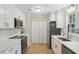 Beautifully updated kitchen featuring white cabinets, stainless appliances, and modern fixtures at 3308 Quail Run Sw Sw Run, Marietta, GA 30008