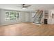 Inviting living room with wood floors, natural light, a staircase, and an open layout to the kitchen at 3308 Quail Run Sw Sw Run, Marietta, GA 30008