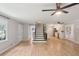Open-concept living space with wood floors, modern ceiling fans, and staircase views to the kitchen at 3308 Quail Run Sw Sw Run, Marietta, GA 30008