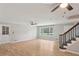 Bright living room with wood floors, a staircase, and plenty of natural light through large windows at 3308 Quail Run Sw Sw Run, Marietta, GA 30008