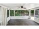 Enclosed porch area with curtains, wood floors, and a view of the wooded backyard at 3308 Quail Run Sw Sw Run, Marietta, GA 30008