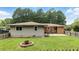 Backyard with a green lawn, small patio, and mature trees at 4065 Old Austell Rd, Powder Springs, GA 30127