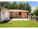 Brick patio and fenced backyard with green lawn at 4065 Old Austell Rd, Powder Springs, GA 30127