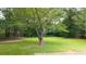 Spacious backyard with lush green lawn and mature trees, perfect for outdoor activities and relaxation at 4065 Old Austell Rd, Powder Springs, GA 30127