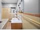 Bathroom with bathtub, tile walls, wood vanity, sink, and mirror at 4065 Old Austell Rd, Powder Springs, GA 30127