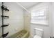 Bathroom features a retro bathtub, a white toilet, and a window with natural light at 4065 Old Austell Rd, Powder Springs, GA 30127