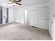Bedroom featuring neutral carpet, white walls, ceiling fan, and natural light from the window at 4065 Old Austell Rd, Powder Springs, GA 30127