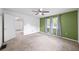 Bedroom featuring green accent wall, neutral carpet, and natural light from the windows at 4065 Old Austell Rd, Powder Springs, GA 30127