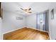 Light filled bedroom with hardwood floors, ceiling fan, and natural light from the window at 4065 Old Austell Rd, Powder Springs, GA 30127