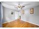 Bedroom features hardwood floors, ceiling fan, and natural light from the window at 4065 Old Austell Rd, Powder Springs, GA 30127
