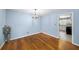 Cozy dining room with hardwood floors and modern lighting fixture, adjacent to the kitchen at 4065 Old Austell Rd, Powder Springs, GA 30127