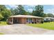 Single-story brick home with a covered carport and long driveway at 4065 Old Austell Rd, Powder Springs, GA 30127