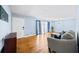 Bright living room with hardwood floors, a cozy gray couch, and natural light from the window at 4065 Old Austell Rd, Powder Springs, GA 30127