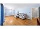 Inviting living room featuring hardwood floors, light blue walls, and a comfortable gray sectional at 4065 Old Austell Rd, Powder Springs, GA 30127