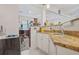 Bar area featuring white cabinets, granite countertops, and a tile backsplash at 7523 Kimberly Lynn Ct, Lithonia, GA 30058