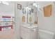 Bright bathroom featuring white vanity, framed mirror, and decorative wall art adjacent to the second story landing at 7523 Kimberly Lynn Ct, Lithonia, GA 30058