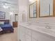Bathroom with a double sink vanity, framed mirrors, and view into the adjacent bedroom, creating a relaxing atmosphere at 7523 Kimberly Lynn Ct, Lithonia, GA 30058