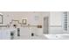 Bright bathroom featuring a soaking tub and ample vanity space at 7523 Kimberly Lynn Ct, Lithonia, GA 30058