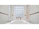 Large soaking tub near window with natural light at 7523 Kimberly Lynn Ct, Lithonia, GA 30058