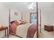Comfortable bedroom with a four-poster bed, ceiling fan and neutral carpeting, illuminated by natural light at 7523 Kimberly Lynn Ct, Lithonia, GA 30058