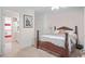 Cozy bedroom with an adjacent bathroom and staircase, decorated with framed artwork at 7523 Kimberly Lynn Ct, Lithonia, GA 30058