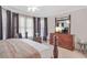 Bedroom featuring a large dresser with a TV, a ceiling fan, and dark purple curtains at 7523 Kimberly Lynn Ct, Lithonia, GA 30058