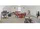 Spacious bonus room with work spaces, a seating area, and neutral carpeting at 7523 Kimberly Lynn Ct, Lithonia, GA 30058