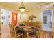 Dining room featuring tray ceilings, hardwood floors, and access to the kitchen at 7523 Kimberly Lynn Ct, Lithonia, GA 30058