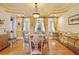 Formal dining room with decorative ceiling, natural light, and hardwood floors at 7523 Kimberly Lynn Ct, Lithonia, GA 30058