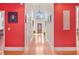 Entryway with hardwood floors, red walls, and a view of the front door at 7523 Kimberly Lynn Ct, Lithonia, GA 30058