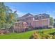 Stunning brick home showcasing a spacious outdoor deck and lush landscaping at 7523 Kimberly Lynn Ct, Lithonia, GA 30058
