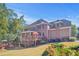 Stunning brick home showcasing a spacious outdoor deck and lush landscaping at 7523 Kimberly Lynn Ct, Lithonia, GA 30058