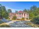 A grand brick home with a well-manicured front lawn and long driveway at 7523 Kimberly Lynn Ct, Lithonia, GA 30058