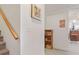 Hallway with stairway, bookcase, and view to a bar and island with seating at 7523 Kimberly Lynn Ct, Lithonia, GA 30058