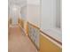 Well-lit hallway featuring neutral walls with painted accent, wooden railing and a glimpse of the staircase at 7523 Kimberly Lynn Ct, Lithonia, GA 30058