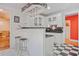 Kitchen boasting checkerboard flooring, breakfast bar seating, and modern pendant lighting at 7523 Kimberly Lynn Ct, Lithonia, GA 30058