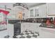 Eat-in kitchen featuring black and white checkered floors, white cabinetry, and modern appliances at 7523 Kimberly Lynn Ct, Lithonia, GA 30058