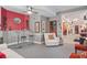 Cozy living room with bar area, neutral walls, bright red accent, and open doorway at 7523 Kimberly Lynn Ct, Lithonia, GA 30058
