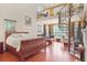 Spacious main bedroom featuring a spiral staircase and large windows at 7523 Kimberly Lynn Ct, Lithonia, GA 30058