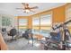 Bright home office with multiple windows, telescope, ceiling fan, and a workspace with a desk at 7523 Kimberly Lynn Ct, Lithonia, GA 30058
