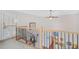 A staircase with black metal railings and light wooden bannister overlooks the floor below at 7523 Kimberly Lynn Ct, Lithonia, GA 30058
