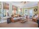 Bright sunroom with wicker furniture, large windows, and natural light at 7523 Kimberly Lynn Ct, Lithonia, GA 30058