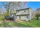 Exterior view of the home displaying its backyard, deck, and surrounding trees; perfect for outdoor activities at 840 Wells Se Cir, Smyrna, GA 30080
