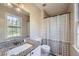 Updated bathroom featuring granite countertops, modern fixtures, and a shower with a patterned curtain at 840 Wells Se Cir, Smyrna, GA 30080