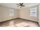 Bright and airy bedroom with wood-look flooring, neutral walls, and two windows providing natural light at 840 Wells Se Cir, Smyrna, GA 30080