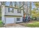 Charming split-level home with a one-car garage, gray siding, and black shutters nestled amongst trees at 840 Wells Se Cir, Smyrna, GA 30080