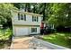 Charming two-story home featuring a well-maintained front yard, a garage and a striking red front door at 840 Wells Se Cir, Smyrna, GA 30080