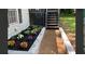 Home's landscaped walkway leading to the front door features lush flower beds and manicured plants at 840 Wells Se Cir, Smyrna, GA 30080
