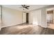 Spacious main bedroom features wood-look flooring, a ceiling fan, and an en-suite bathroom at 840 Wells Se Cir, Smyrna, GA 30080